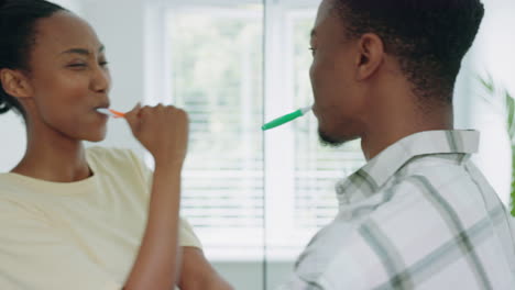 couple, brushing teeth and dance in a bathroom