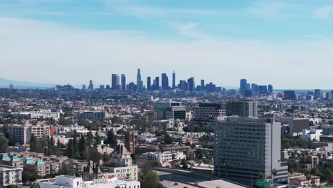 Telephoto-drone-shot-of-the-los-angeles-skyline-during-a-sunny-day-panning-left