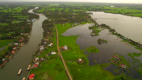 aerial view revealing tropical green and rural landscape of kumarakom river, kerala