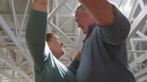 caucasian senior couple spending time together and dancing in a ballroom