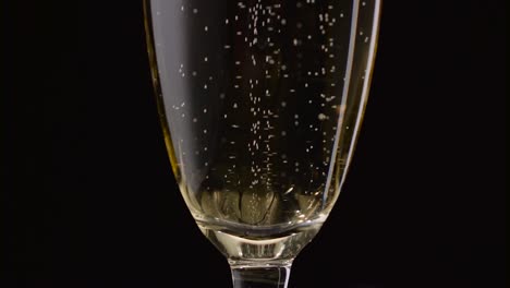 champagne glasses with champagne rotating on a black background champagne glasses with champagne rotating on a black background concept celebrating time new years eve valentines day
