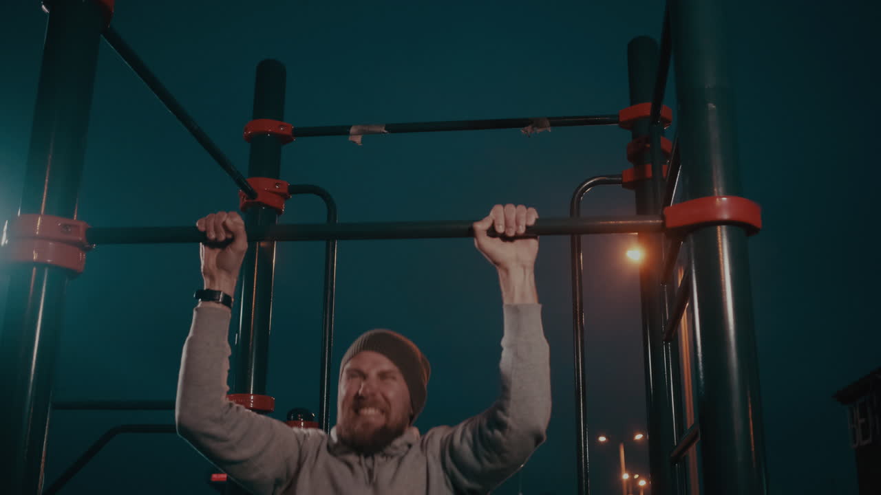 밤에 풀업을 하는 남자