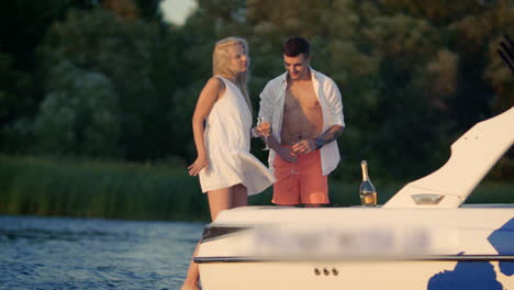 Happy-girl-dancing-on-yacht.-Young-lovely-couple-have-fun-on-yacht