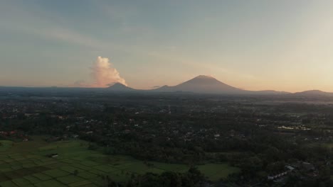 Magical-morning-sunrise-above-Ubud-with-mount-Agung-and-Abang-on-horizon,-aerial