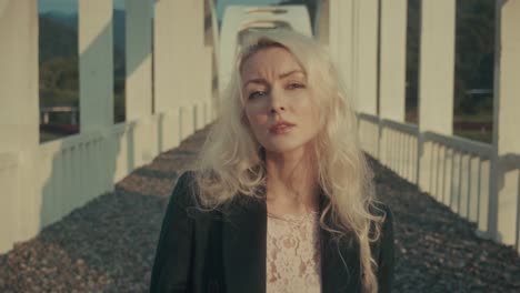 blonde woman on a bridge
