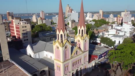 Circling-Aerial-view-of-a-cathedral-church-surrounded-by-urban-buildings-in-Posadas-city-of-Argentina