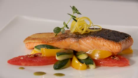 Gourmet-pan-seared-salmon-fillet-with-skin-on,-served-on-a-white-plate-with-colorful-vegetables