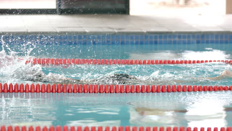 swimming in pool, athlete practicing freestyle stroke during training session