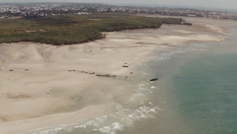 Vast-open-beach-with-fishing-boat-ashore-near-Stone-Town-Zanzibar-Tanzania