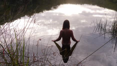 back view of half naked woman dipping in the lake in naree budjong djara national park, north stradbroke island, queensland, australia - high angle, wide shot