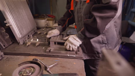 metalworking: machinist in workshop using industrial tools on metal parts with precision