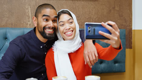 couple taking selfie in cafeteria 4k