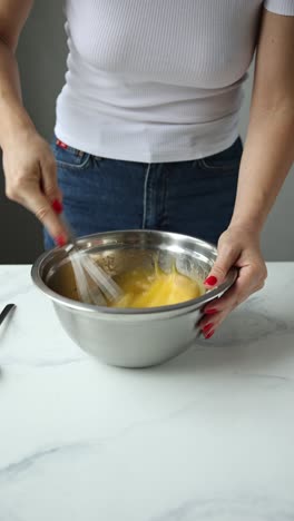 woman mixing eggs for baking