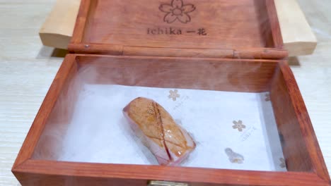 sushi served with smoke in wooden box