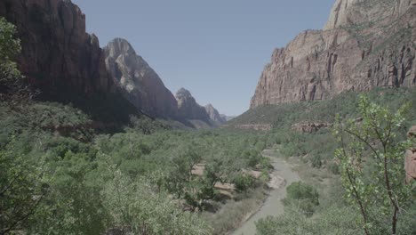 a mountain range with a river flowing through the canyons at zion national park