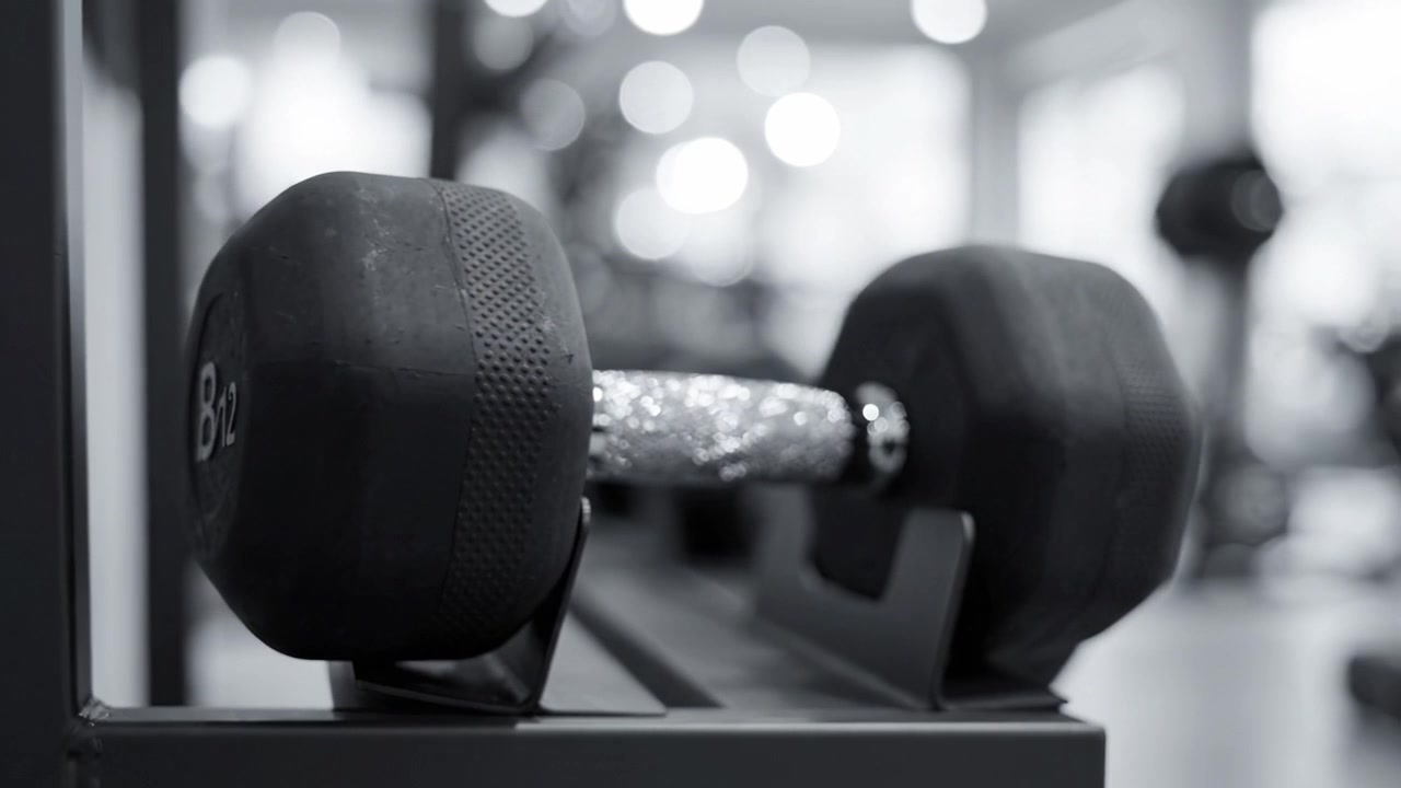 Detailed Close-Up of a Dumbbell in a Fitness Center, Showcasing Strength Training Equipment and Inspirational Workout Environment