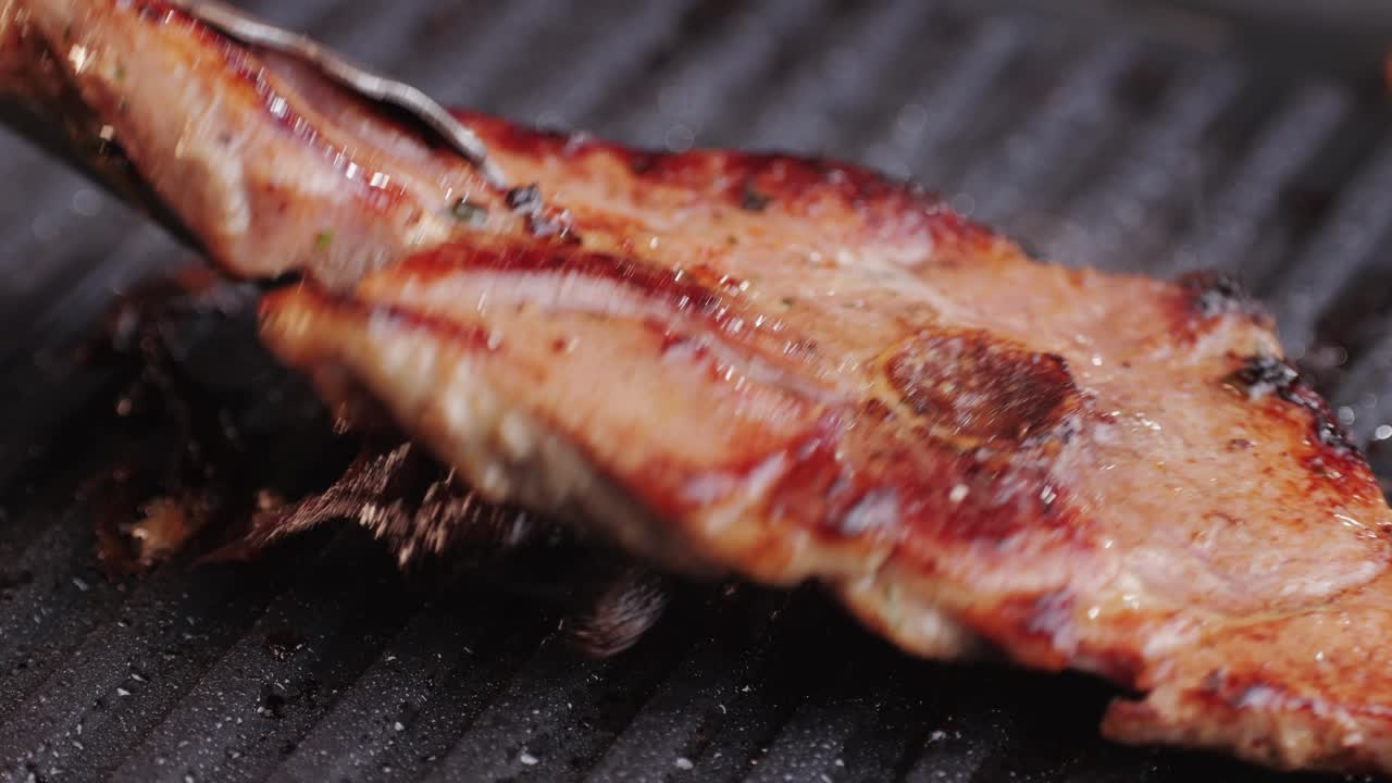 Cooking raw turkey meat in spices with garlic and greens on grill close-up. Fry chicken or turkey slice on frying pan Grilled chicken, duck, turkey kebab with vegetables.