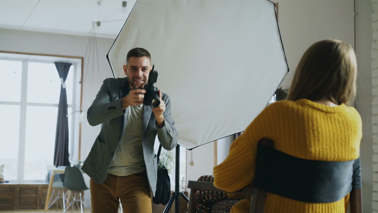 Photographer taking photo of model in studio