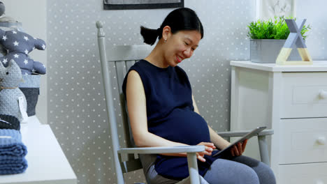 pregnant woman using digital tablet at home 4k