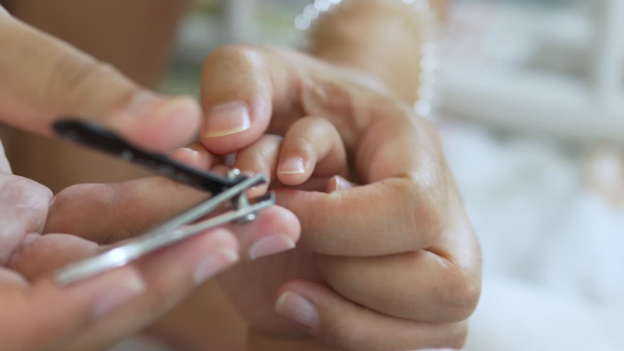 A close-up of a person trimming nails highlighting the importance of personal grooming a serene home environment