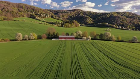 red barn in a rolling green valley