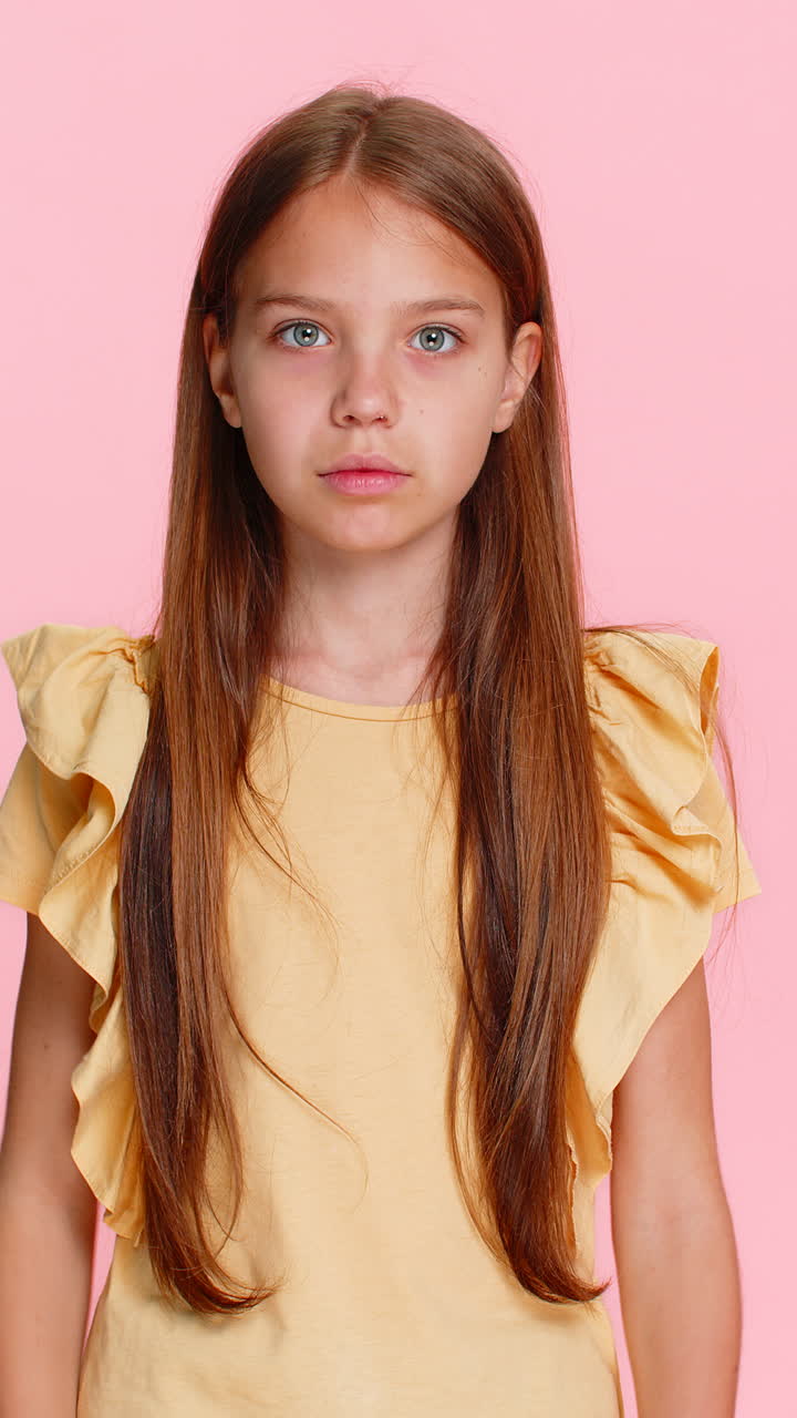 Child girl kid expressing surprise with open mouth and hands on cheeks in wow reaction pose