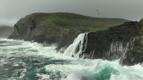 beautiful sørvágsvatn waterfall, wild ocean faroe islands aerial