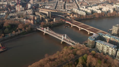 low circling aerial shot over chelsea bridge and grosvenor bridge london