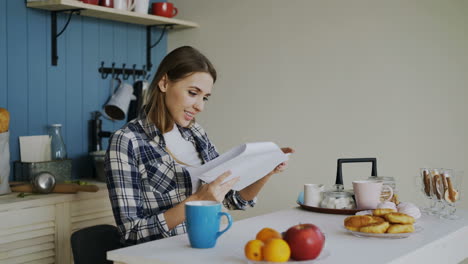 Woman Reading in Kitchen