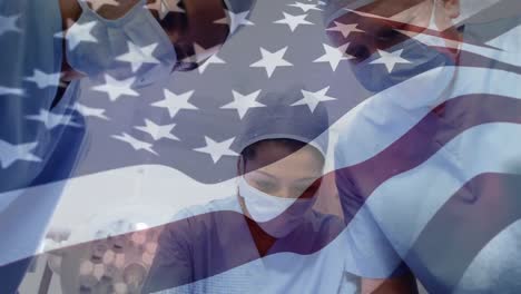 animation of flag of usa waving over surgeons in operating theatre