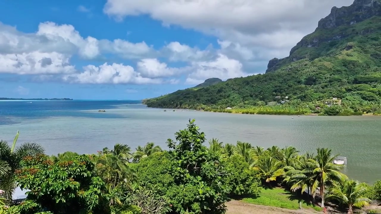 Bora Bora Island, French Polynesia. Lagoon, Bay and Green Tropical Lush Under Hills