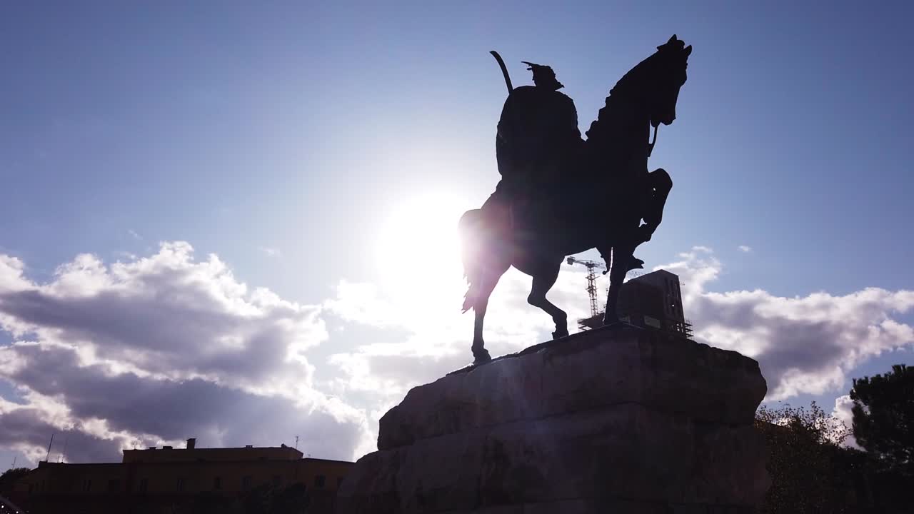 Silhouette of horseman on the horse riding. Statue of Sheshi Skenderbej in Tirana center