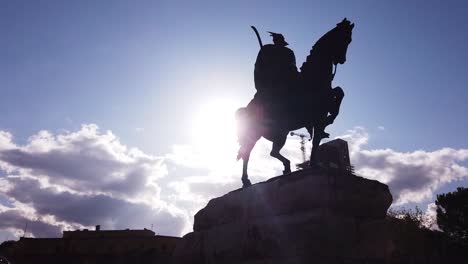 silhouette of horseman on the horse riding. statue of sheshi skenderbej in tirana center