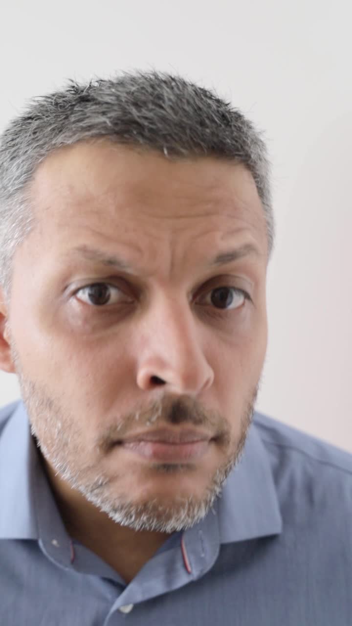 Man with Serious and Curious Expressions on White Background