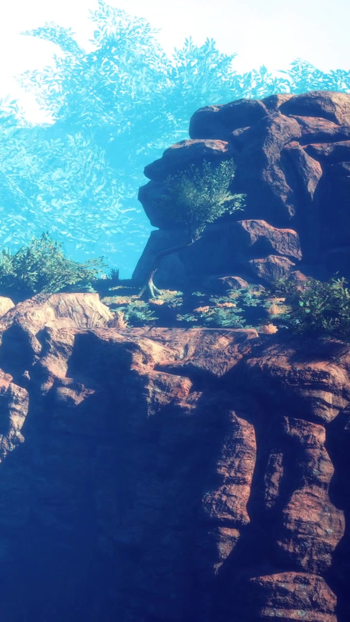 Felsformation mit Grün unter blauem Himmel tagsüber in einem Naturgebiet
