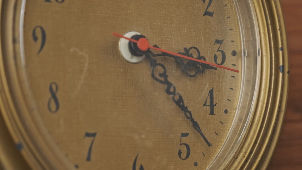 Old Retro Wall Clock with Moving Second Hand on Wooden Background