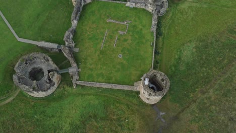 flint castle welsh medieval coastal military fortress ruin aerial view lowering top down shot