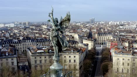 angel of liberty girondins column in bordeaux, france with city panoramic, aerial dolly left reveal