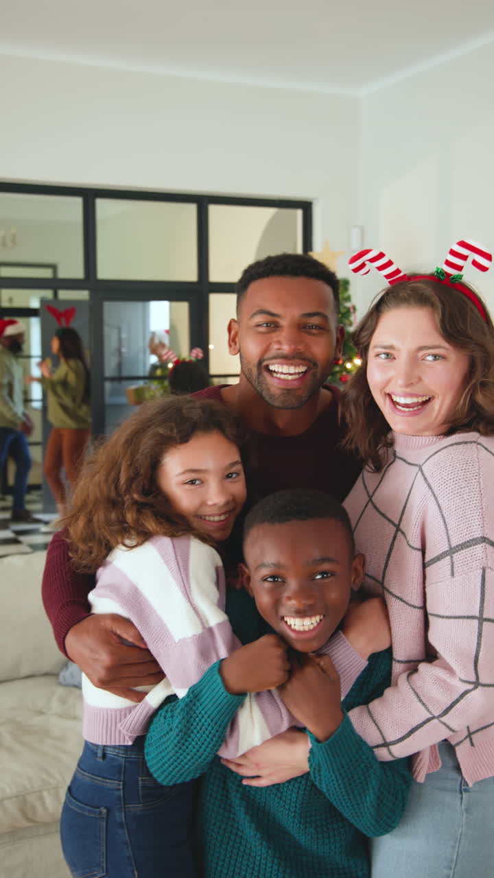 Vertical video: Happy family celebrating Christmas at home, embracing and smiling joyfully together