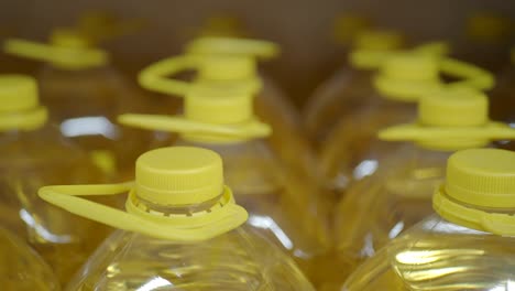 close up of a shelf with yellow cooking oil bottles