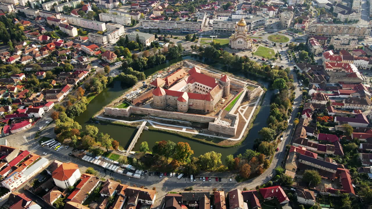 Aerial drone view of the Fagaras, Romania. Fagaras Citadel surrounded by a moat, buildings, roads, greenery