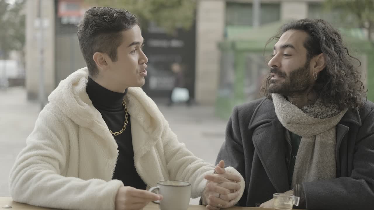 Two men having a conversation at a cafe