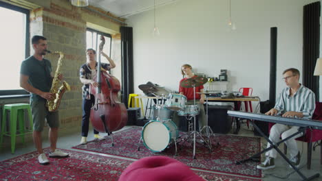 band practicing together in a music studio