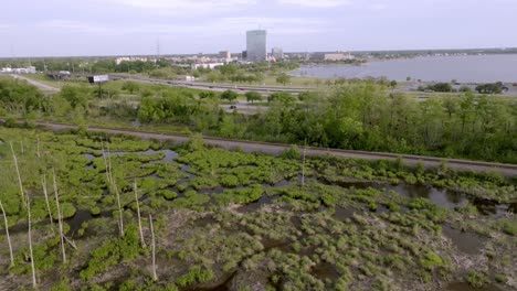 wide shot of lake charles, louisiana skyline with bayou in the foreground