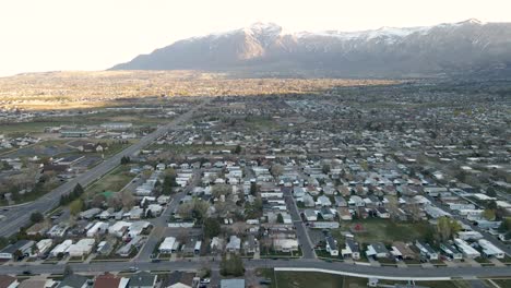 Aerial-shot-of-Ogden-city-in-Utah,-with-Wasatch-Mountains-in-background