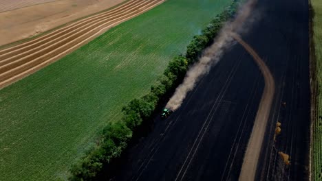 Tractor-Trying-To-Stop-Wildfire-On-Grain-Field---aerial-drone-shot