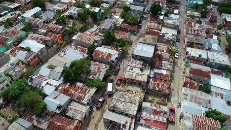 Aerial-view-overlooking-streets-and-rooftops-in-a-slum-district-of-Mexico-city,-cloudy-day---rising,-orbit,-drone-shot