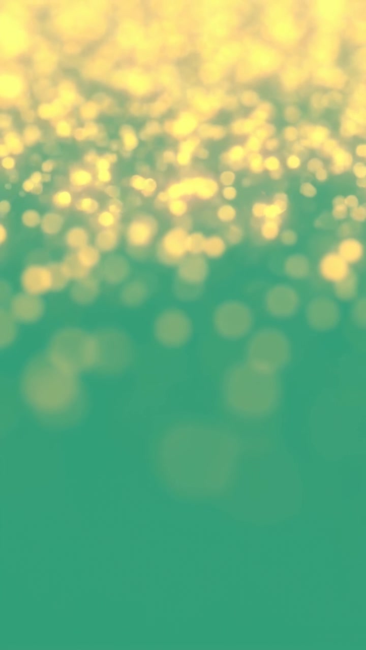 Vertical video: Play starting, golden bokeh drifting and pulsing over teal gradient for wallpaper