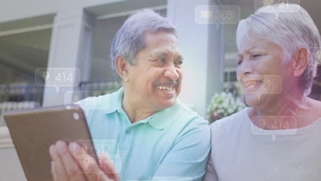 using tablet with social media notifications, elderly couple smiling together