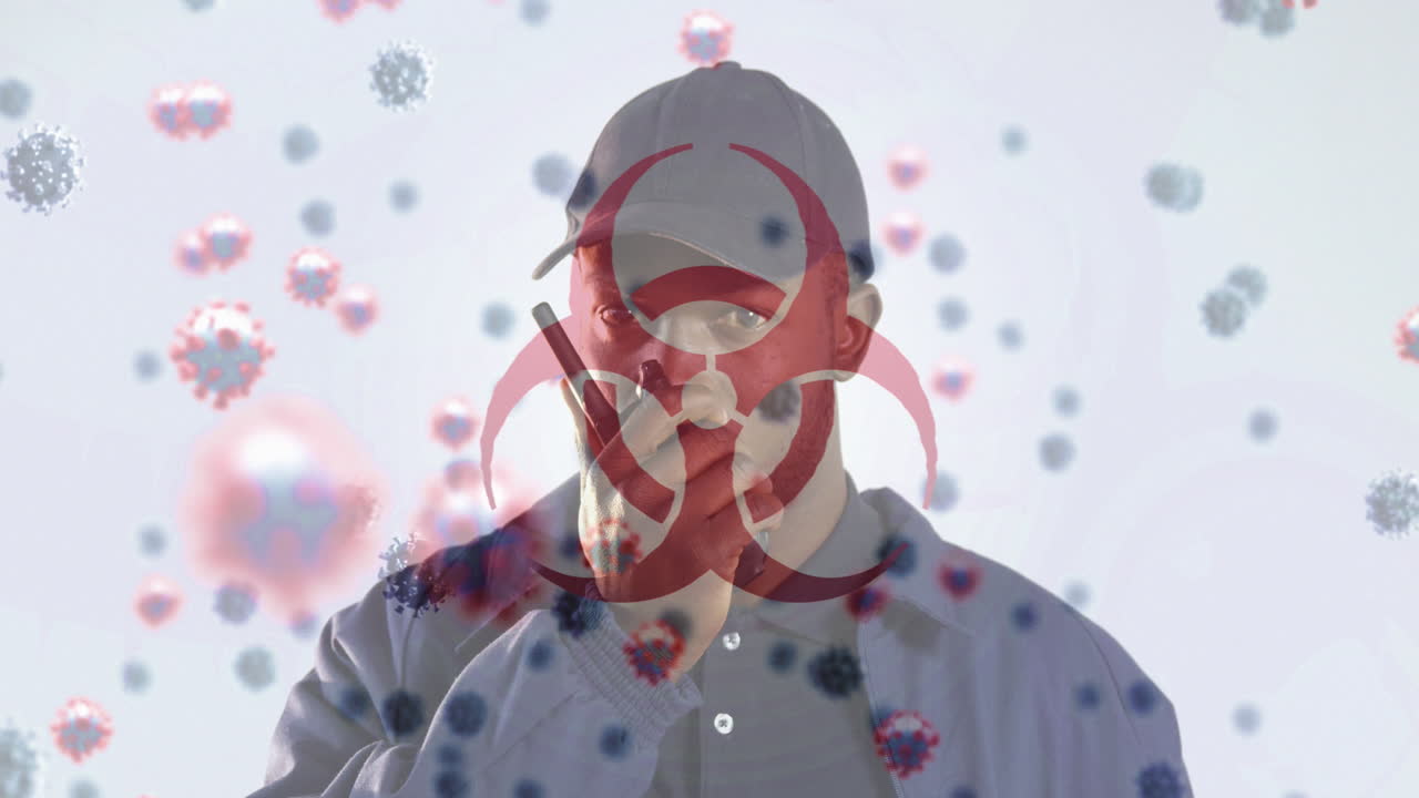 Digital composite video of hazard sign with Covid-19 cells moving against man using a walkie talkie